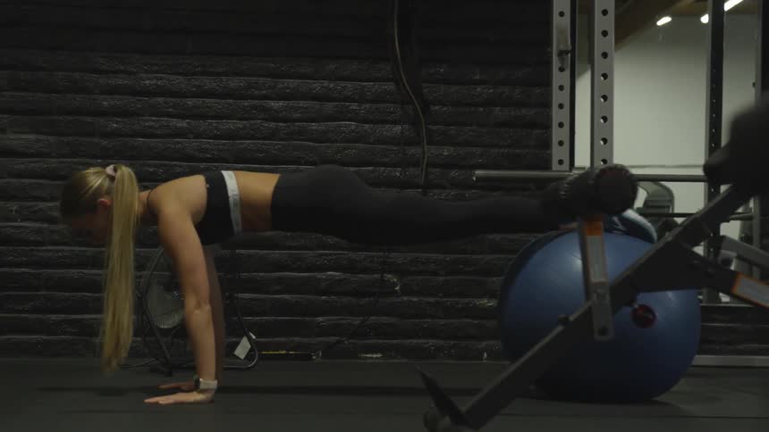 A woman works out with a large ball