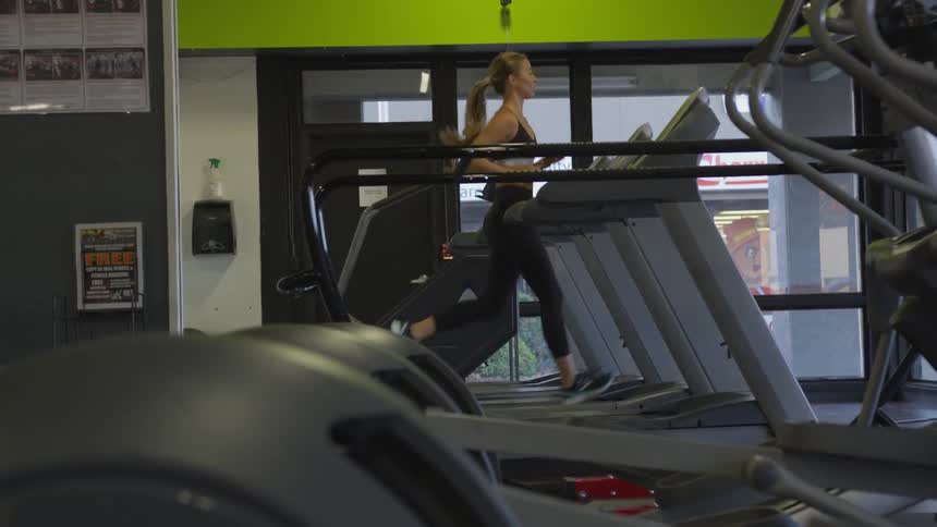 A woman works out on the treadmill
