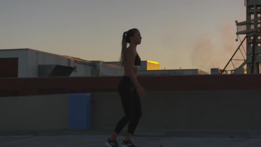 A woman works out on the rooftop