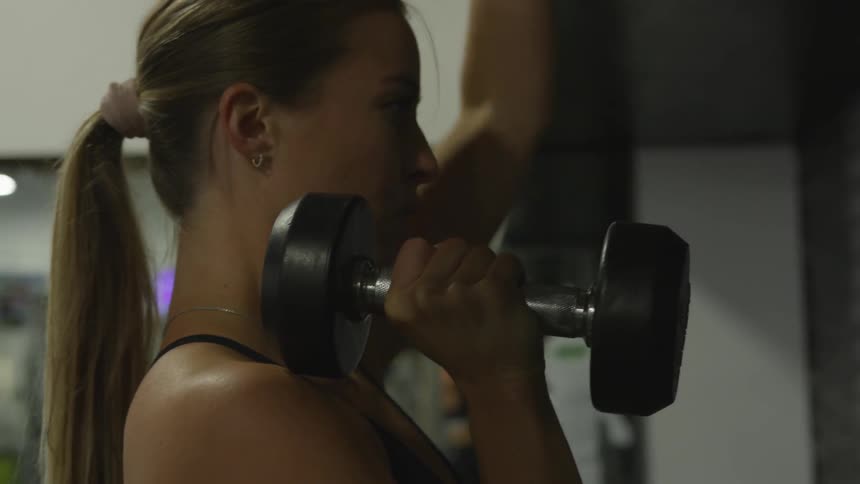 A woman works out with weights