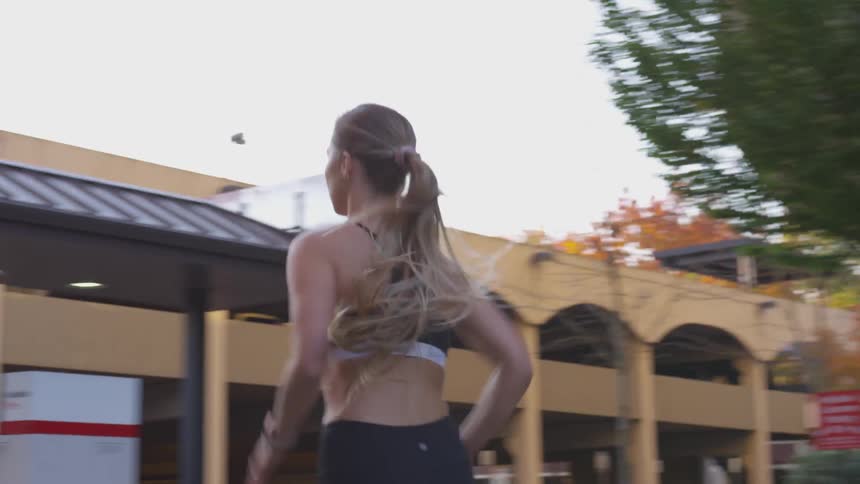 A woman runs through a town