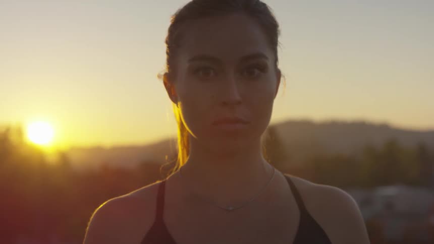A young woman stands ready to compete