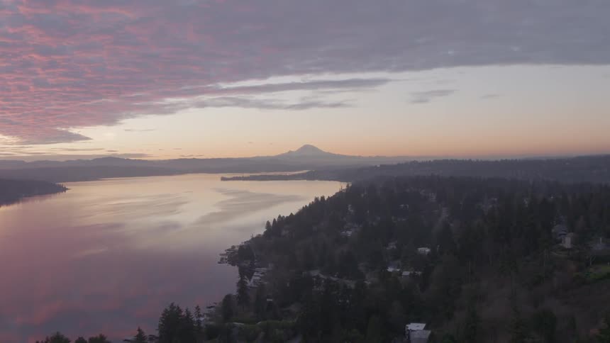 Beautiful sunrise ascent over Lake Washington with Mt. Rainier and downtown Seattle in the distance