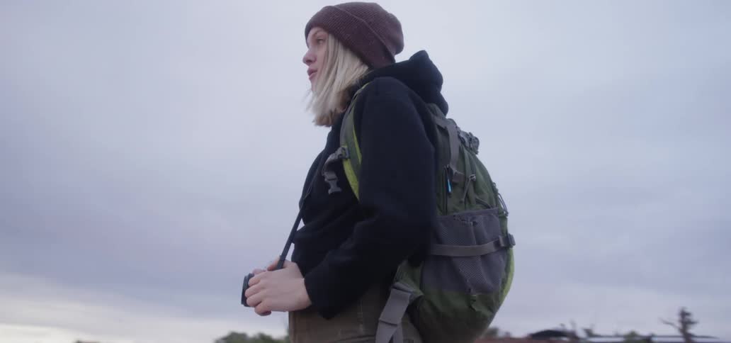 Orbiting shot of a woman holding a camera