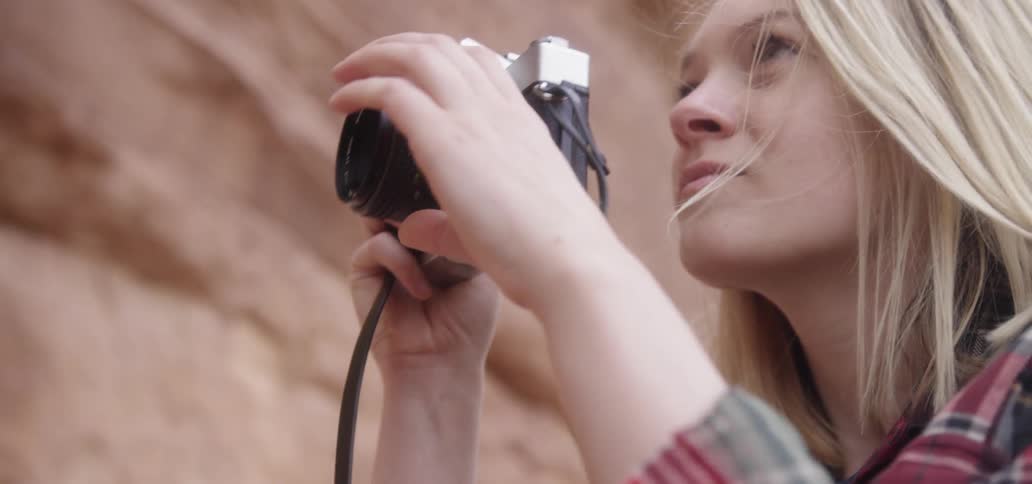 A woman gets ready to snap a picture