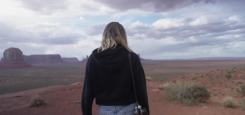 A person walks out to look at a desert vista
