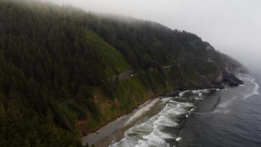Rugged mountain coastline in heavy fog