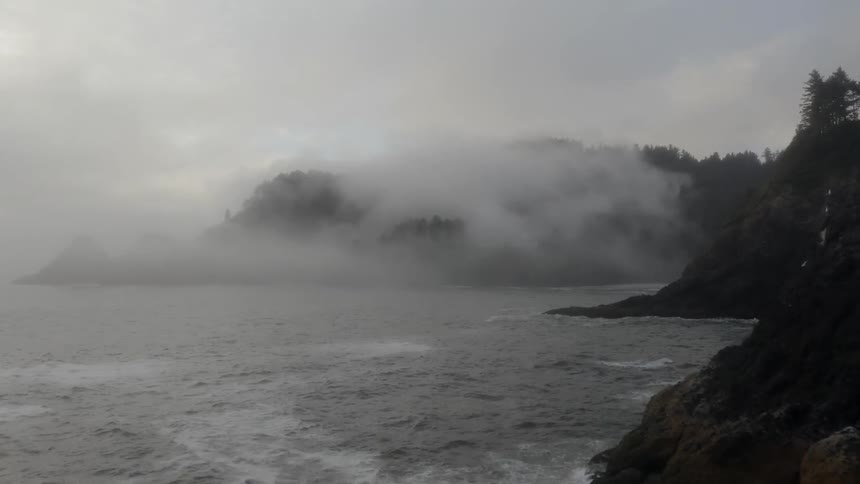 Waves crash upon cliffs at a seaside at day