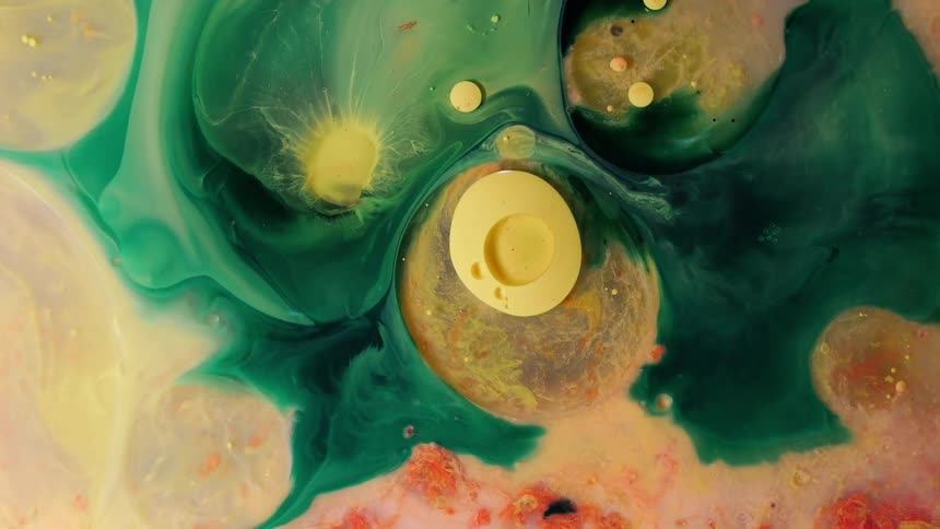 Multiple colors of paint mix and flow along each other