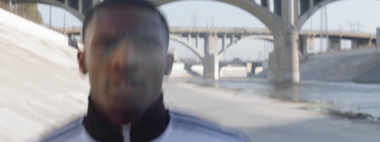 Runner wearing an adidas jacket running in a wash in the city