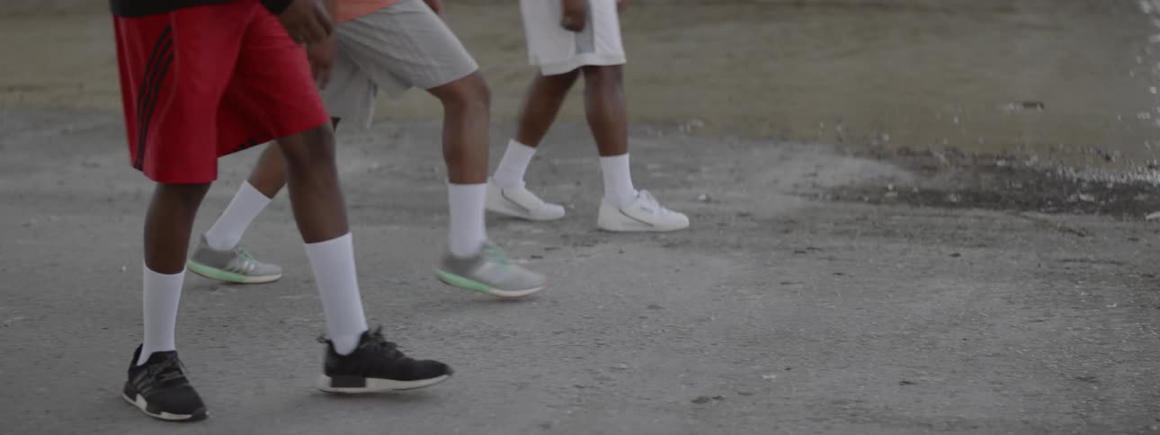 Three black males lining up for a foot race