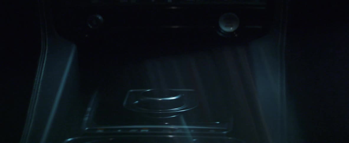 A man presses a button in a car