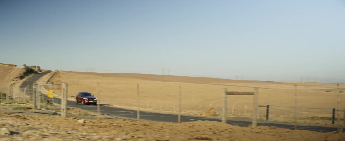 A suv drives down a rural road