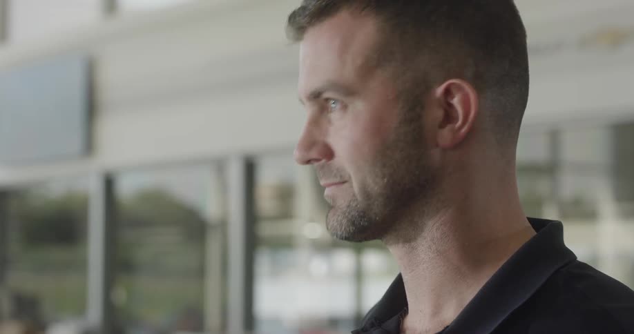 A white male looks around and nods his head