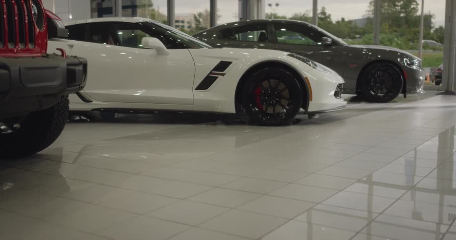 Sports cars sit inside a car dealership