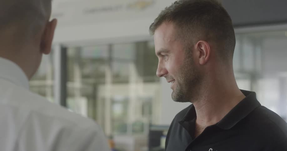 Two men talk to each other in a store