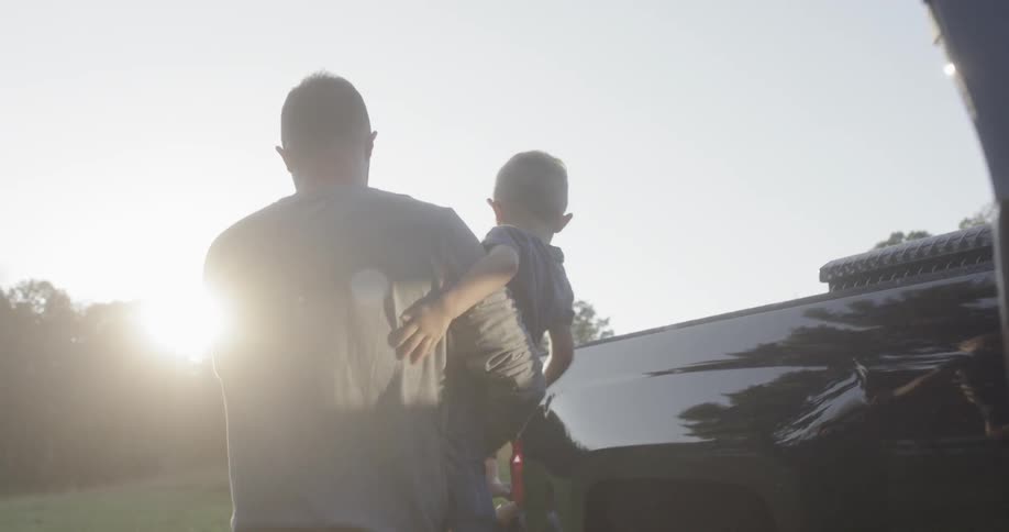 A man getting a child out of a car