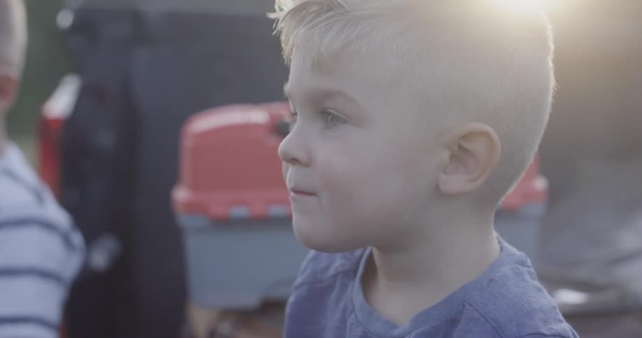 A boy outside staring into the distance