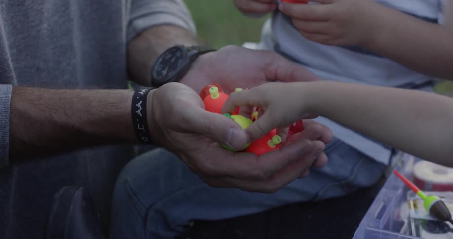 A man hands out toys to children in the yard