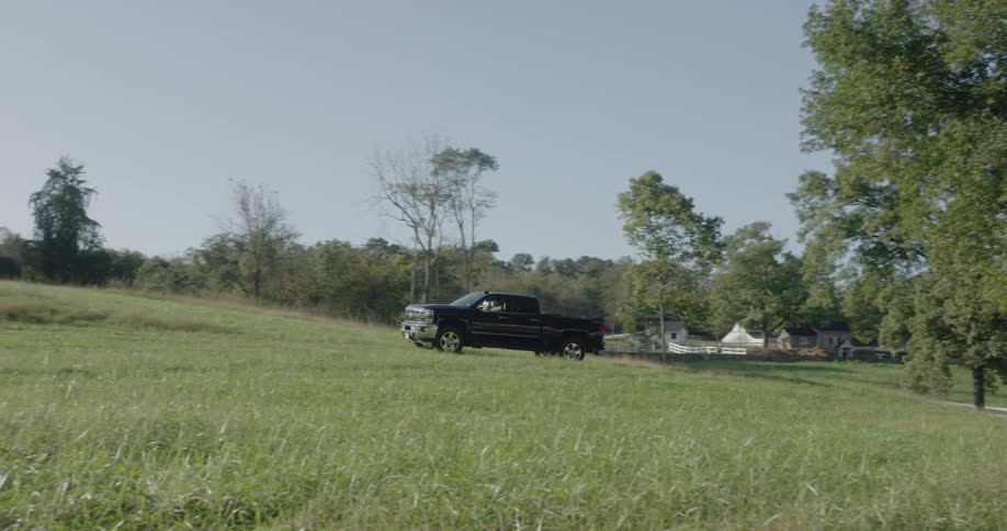 A truck drives over the field