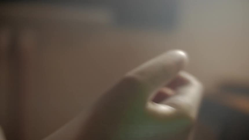 A person pulls on a glove