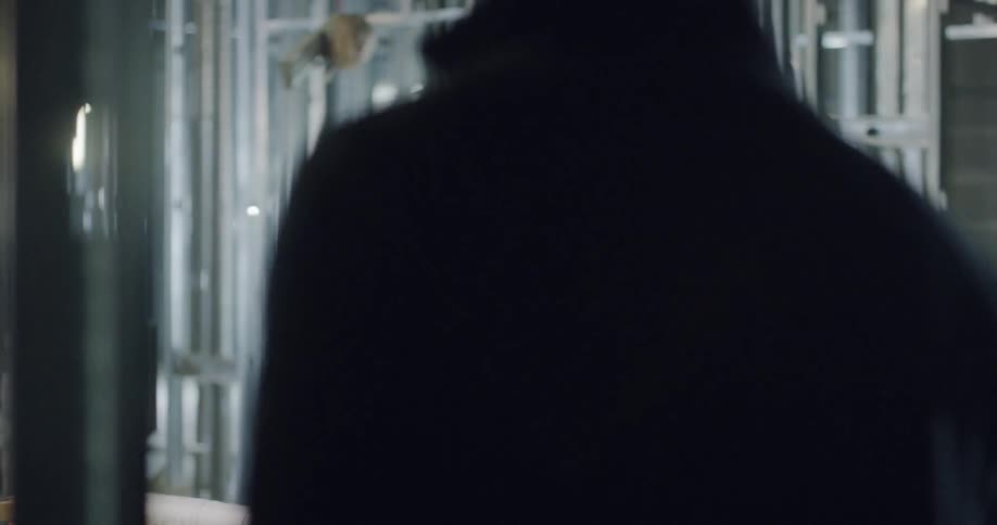 A man walks into a room where another man is