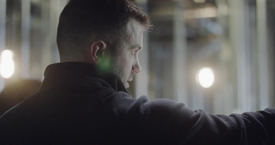 A man is talking to someone indoors