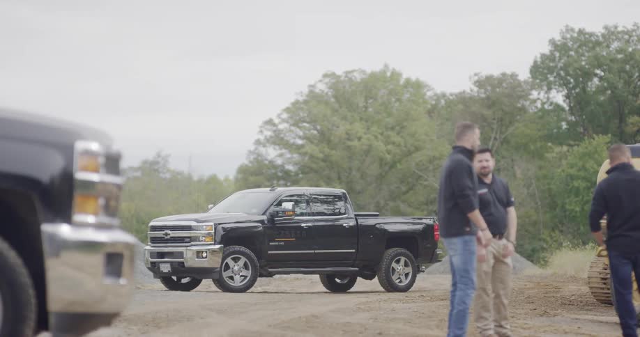 A pickup truck in a dirt lot on a construction site