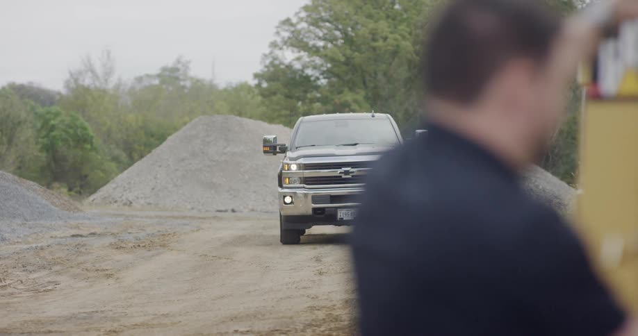 A truck drives on to a job site