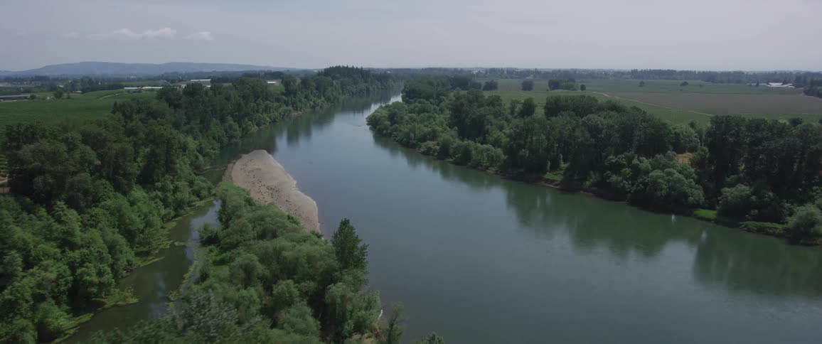 An aerial view of a river flowing through a rural landscape