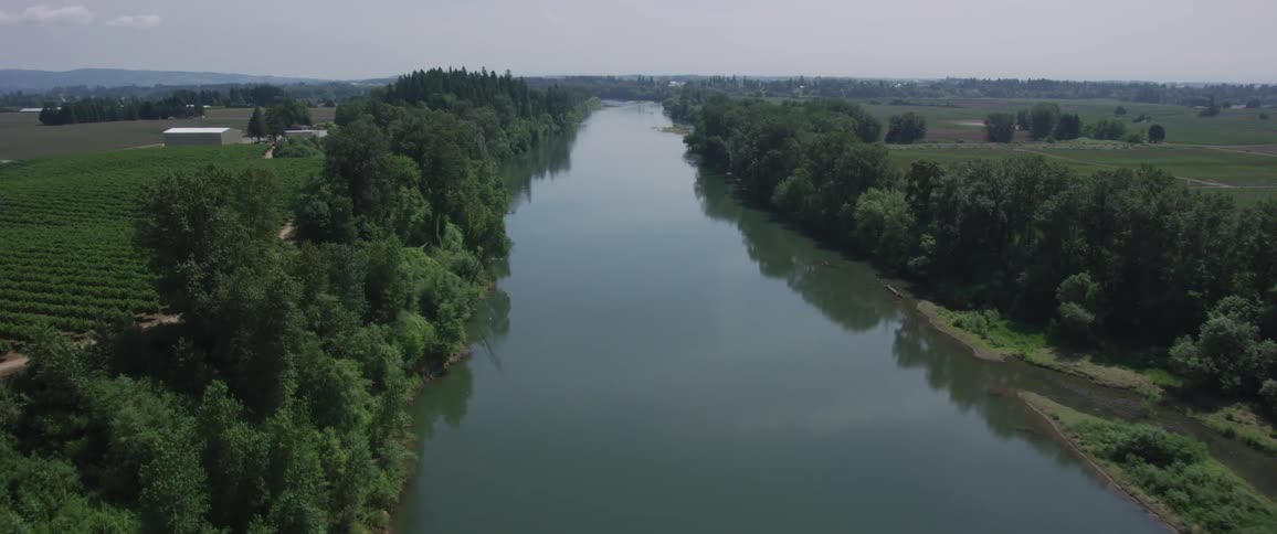 An aerial view of a river flowing through a rural landscape