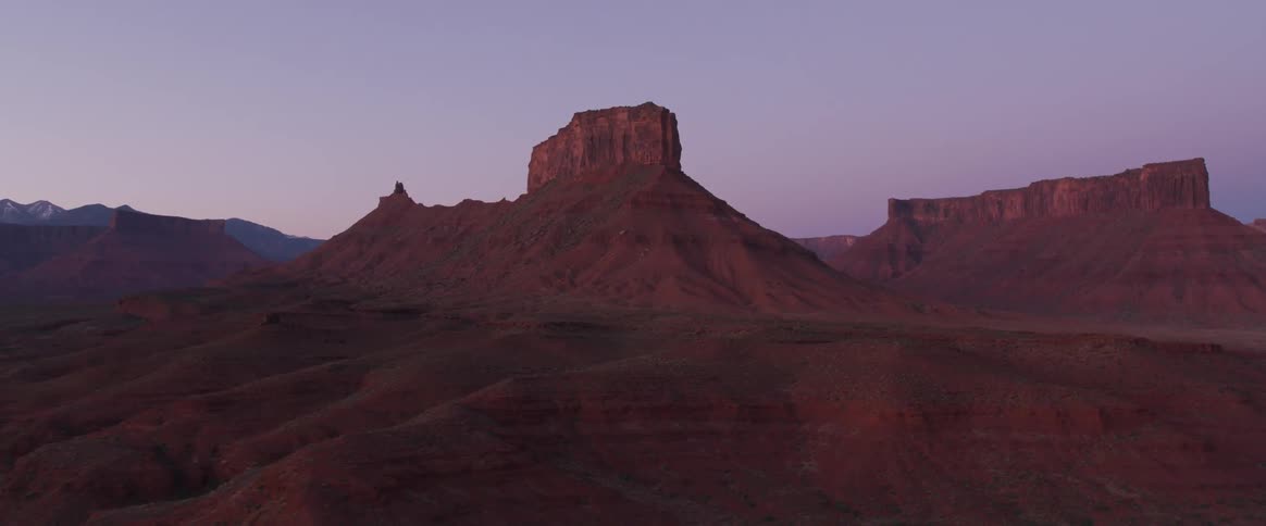 Hills and cliffs sit in the sandy desert