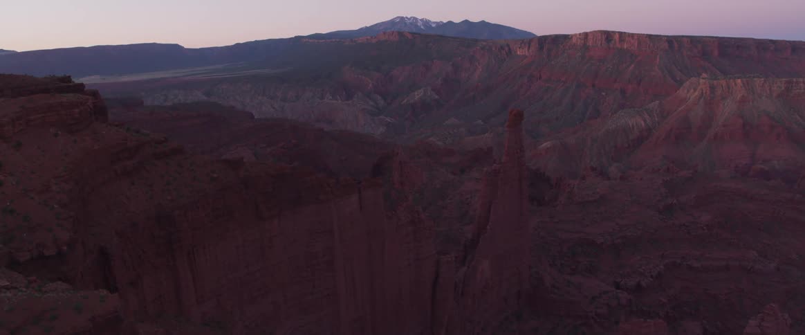 Rock formations loom over a grandiose canyon