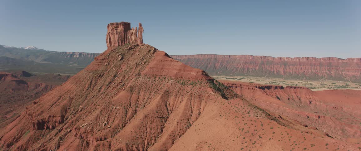 A rock formation is on top of a large hill