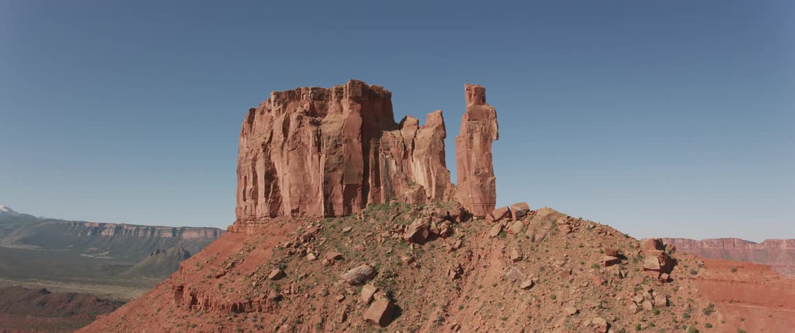 An aerial view of a red rock formation in a desert