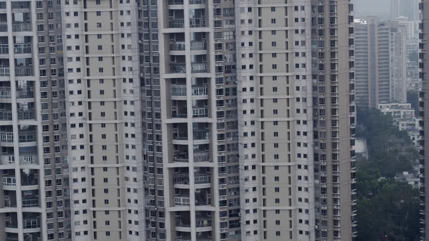 A large building full of apartments in a city