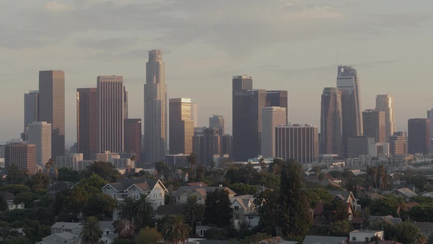 The sun sets on Downtown LA with Echo Park neighborhood in the foreground