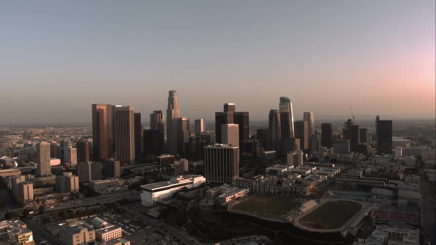 A large urban city sits under a hazy sky