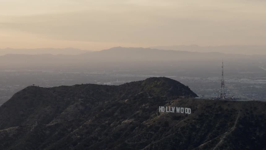 The iconic hollywood sign can be seen on the hillside high above the sprawling metropolitan area