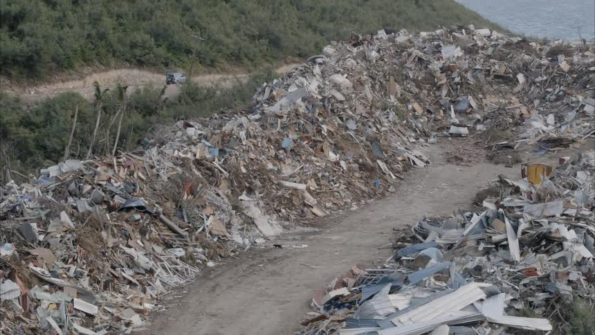 Piles of debris are lined up near the water