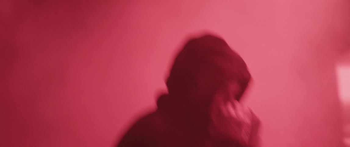 A man with a hood on shadow boxing