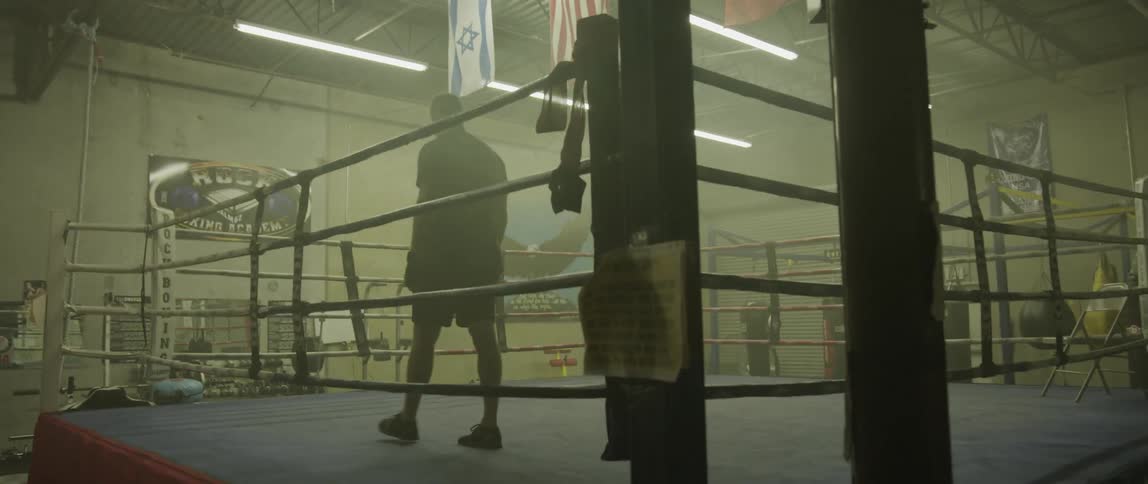 A man walking into a boxing ring