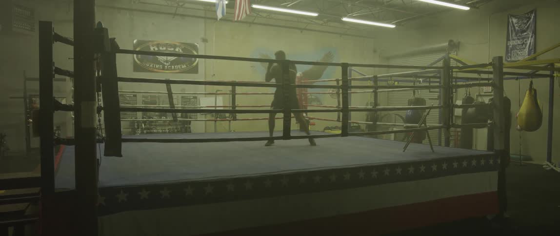 A man is shadow boxing in a ring