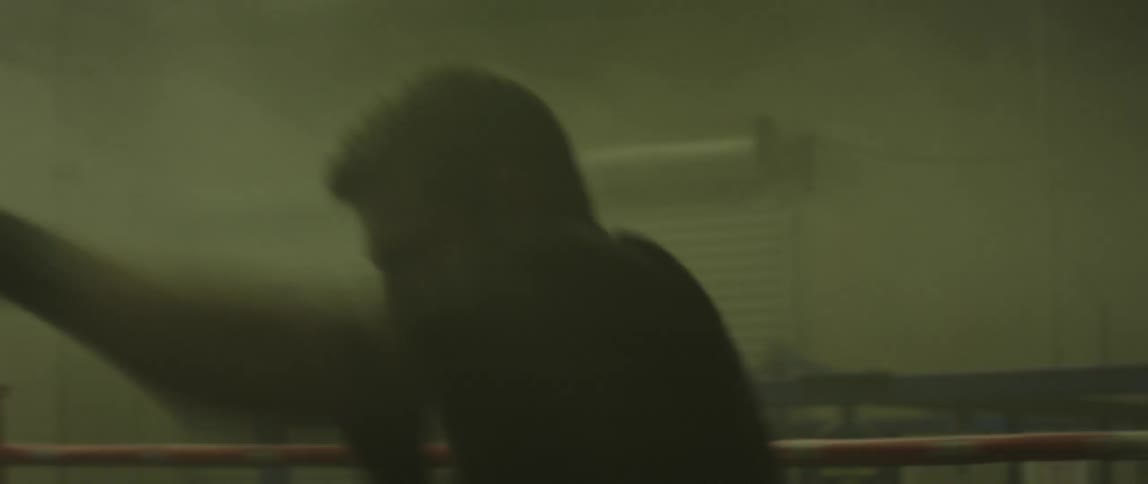 A man in a boxing ring shadow boxing