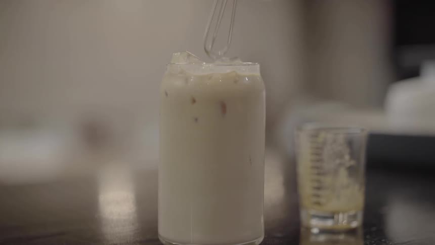 A person stirring a drink in a restaurant