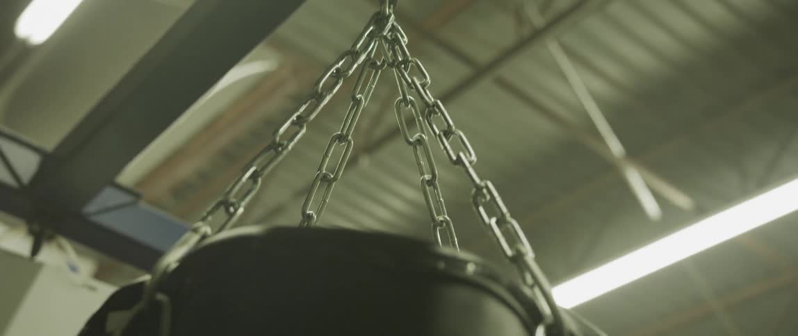 A punching bag hangs from a metal bar