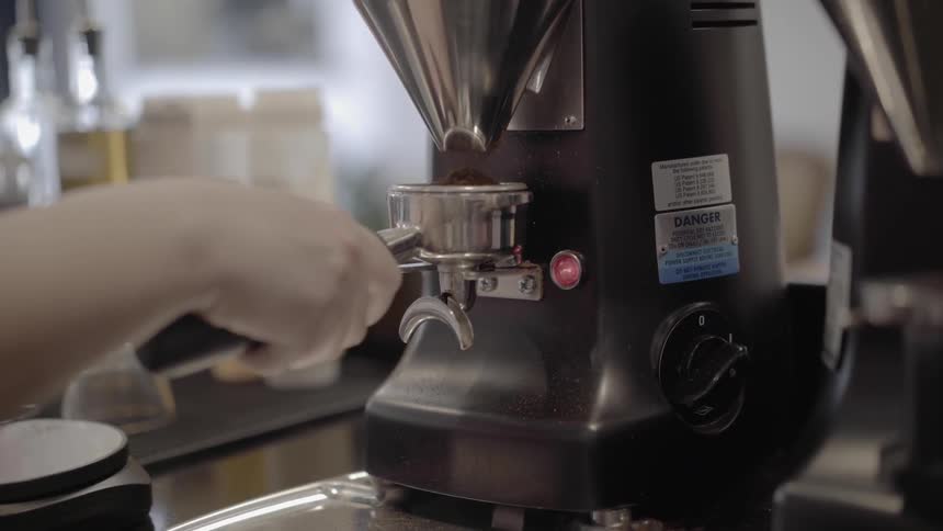 A woman is making coffee