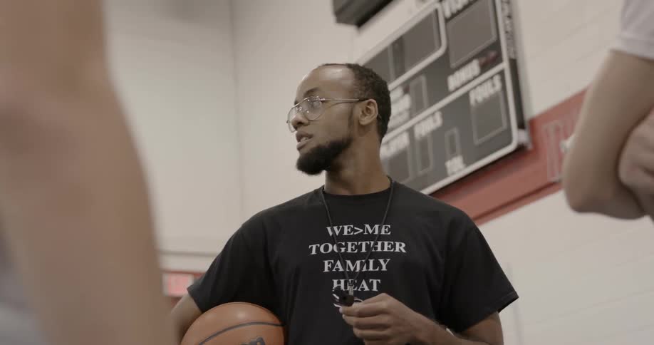 A basketball coach talks to his team