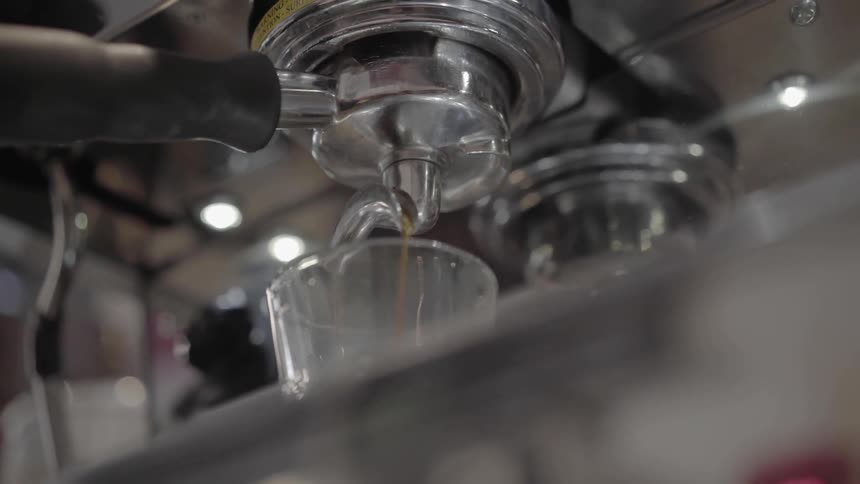 A machine dispenses a hot beverage