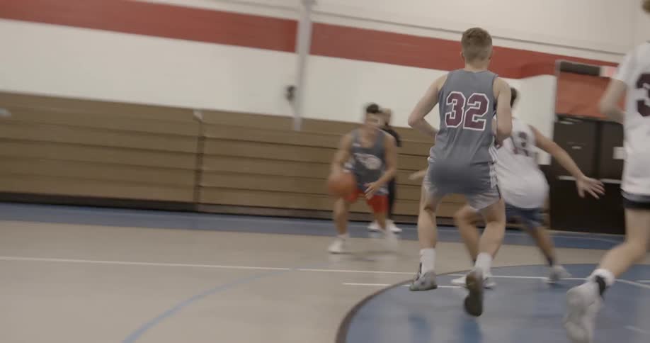 Boys playing basketball together